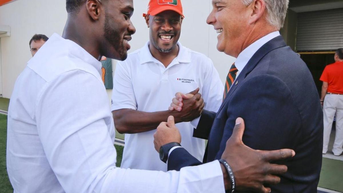 Former football players Jon Beason, left, and Tolbert Bain, at center, with coach Mark Richt during the Carol Soffer Football Indoor Practice Facility groundbreaking ceremony at the University of Miami on Thursday, May 4, 2017.
