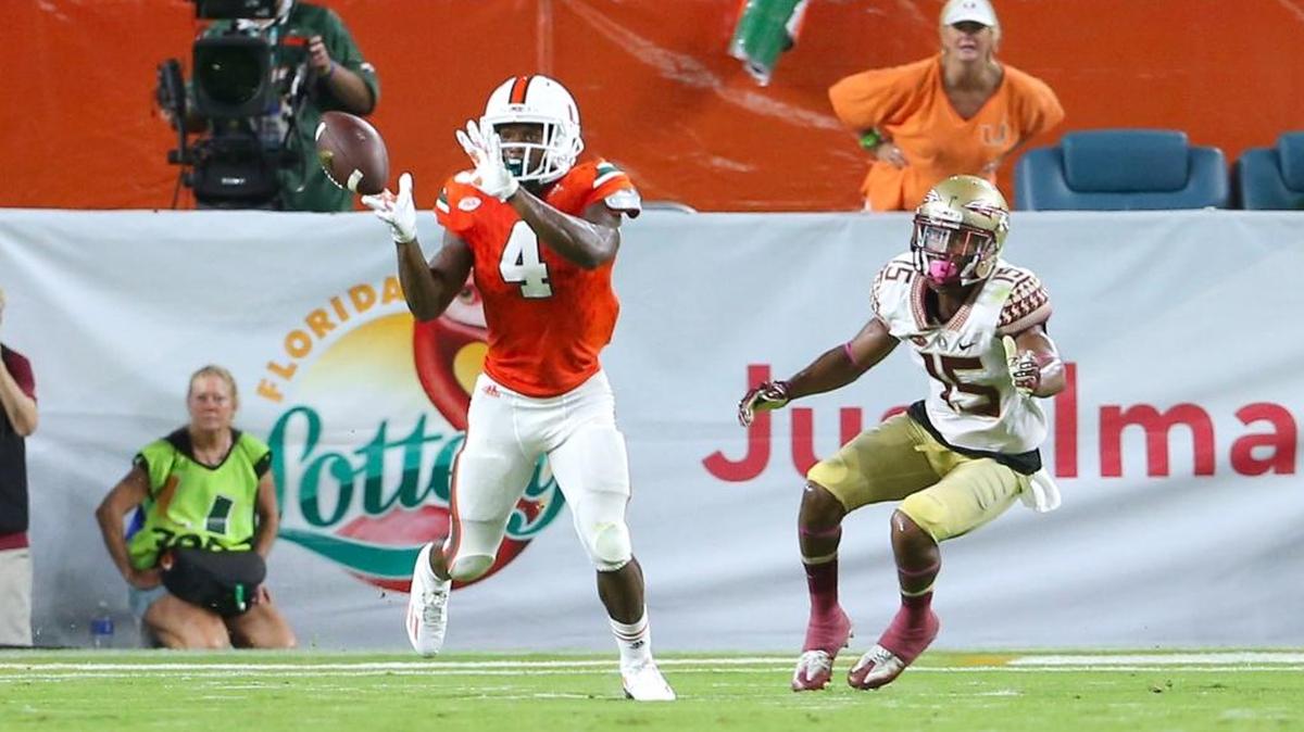 University of Miami Hurricanes defensive back Jaquan Johnson intercepts the ball against Florida State Seminoles wide receiver Travis Rudolph in the second quarter of an NCAA college football game at Hard Rock Stadium on Saturday October 8, 2016, in Miami Gardens.