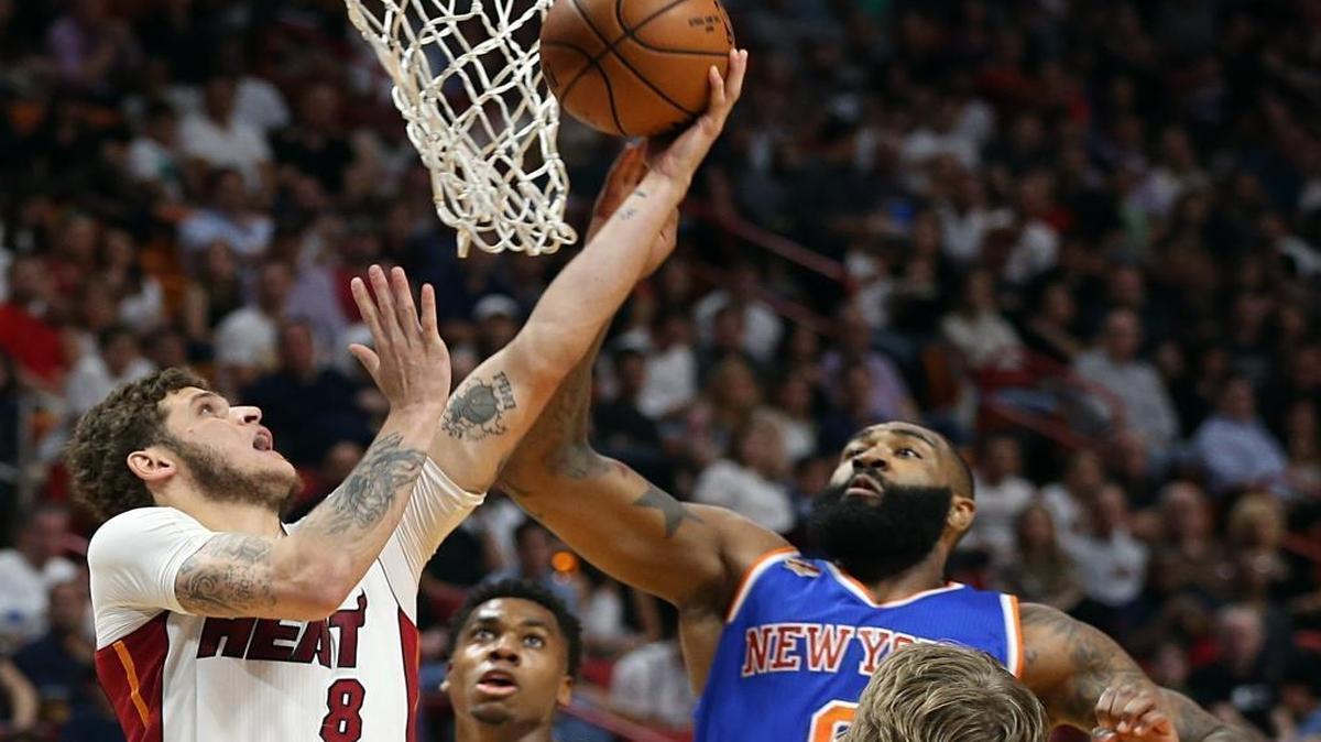 Miami Heat guard Tyler Johnson goes to the basket against Knicks' Kyle O'Quinn, in the fourth quarter of the Miami Heat and New York Knicks game at AmericanAirlines Arena in Miami on Fri., March 31, 2017.