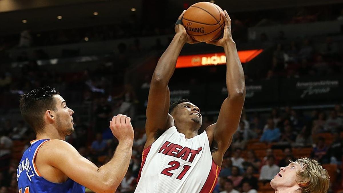 Miami Heat center Hassan Whitside goes to the basket against Knicks' Ron Baker (31) and Willy Hernangomez (14) in the first quarter of the Miami Heat vs New York Knicks at AmericanAirlines Arena in Miami on Friday, March 31, 2017.