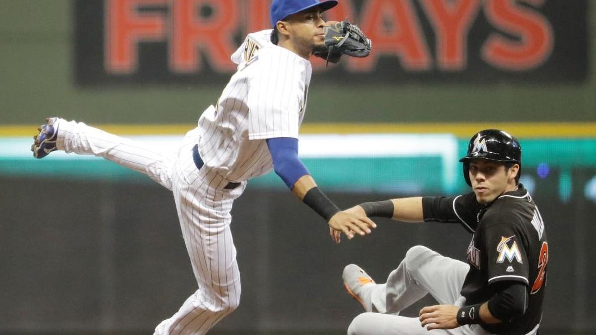 Miami Marlins outfielder Christian Yelich is out at second as Milwaukee Brewers infielder Yadiel Rivera turns a double play on a ball hit by Marcell Ozuna during the fifth inning of a game in April 2016. Rivera announced Friday he has signed with the Marlins. (AP Photo/Morry Gash)