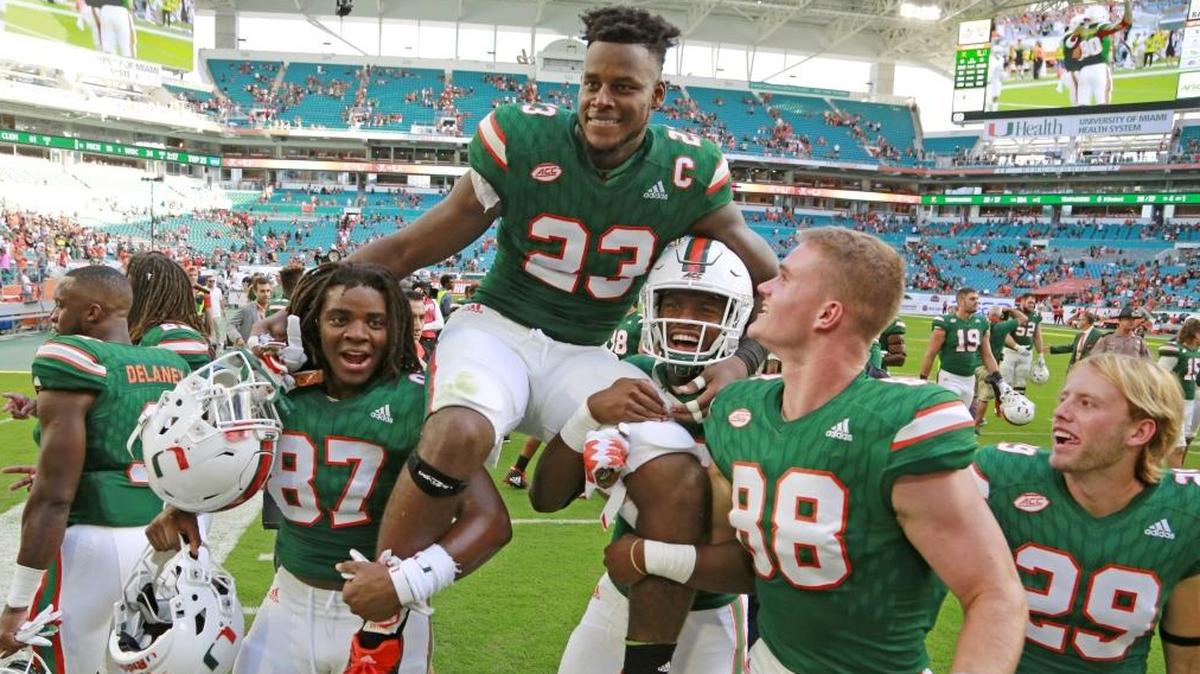 Miami Hurricanes tight end Christopher Herndon IV (23) is carried off by teammates after the University of Miami Hurricanes defeat the Virginia Cavaliers at Hard Rock Stadium on Sat., Nov. 18, 2017.