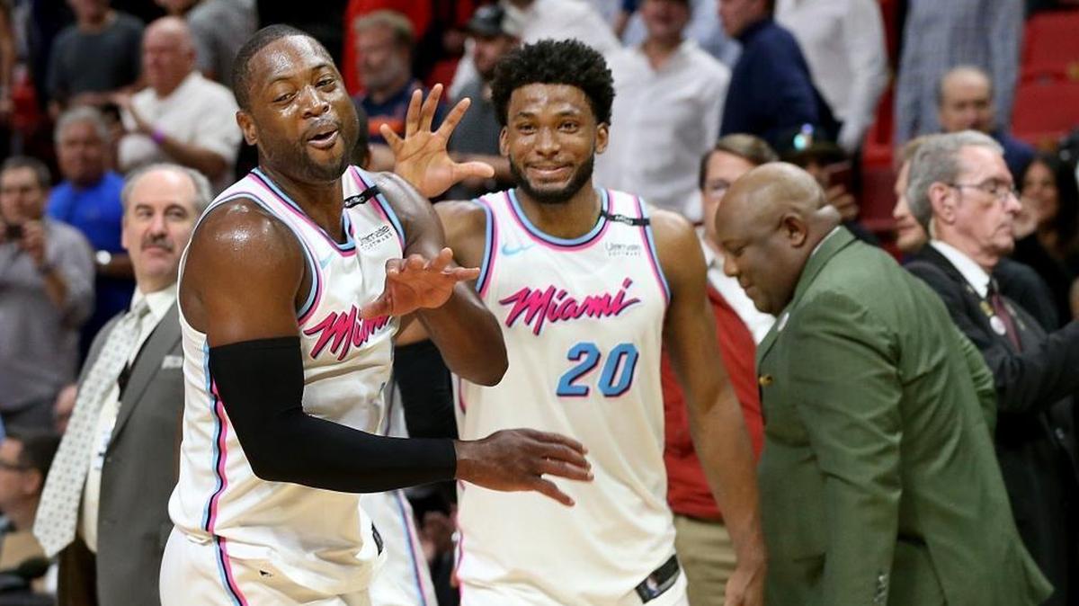 Heat guard Dwyane Wade and forward Justise Winslow celebrate their 108-99 victory against the Philadelphia 76ers, at AmericanAirlines Arena in Miami last month. The Heat and 76ers will meet again in postseason.