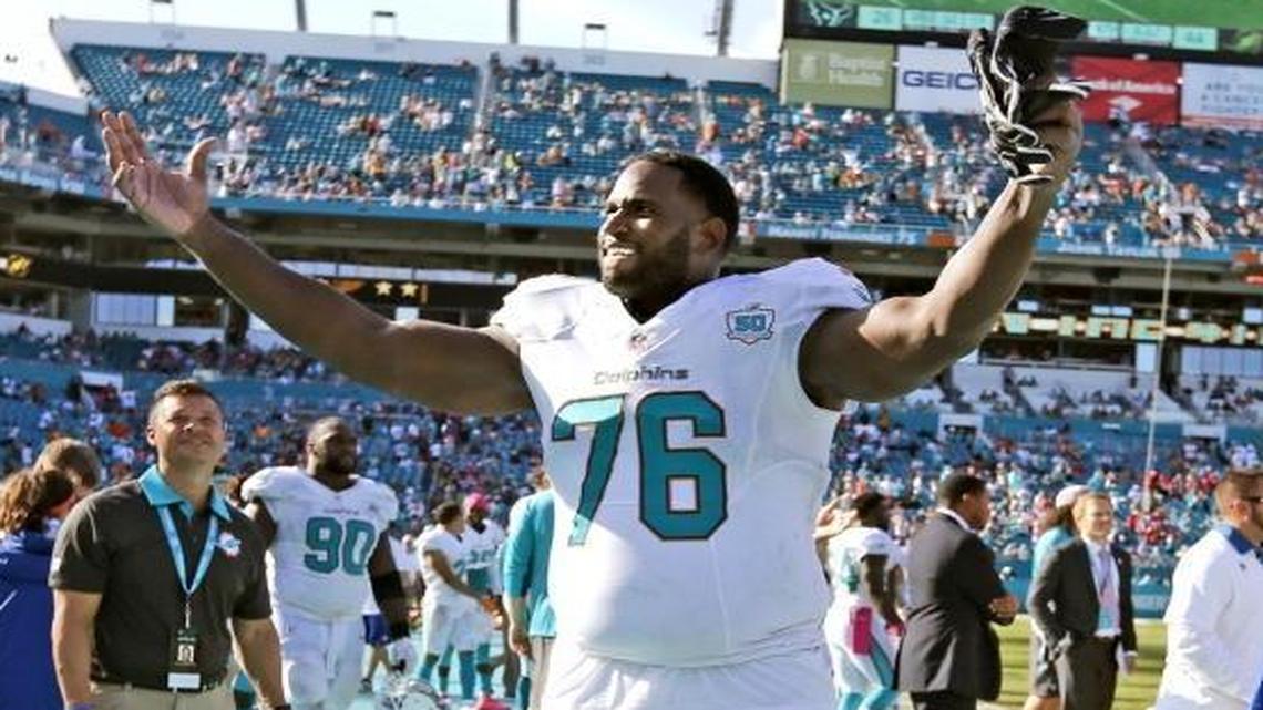 Miami Dolphins offensive tackle Branden Albert (76) motivates the fans as the fourth quarter winds down as Miami hosts the Houston Texans at Sun Life Stadium on Sun., Oct. 25, 2015.