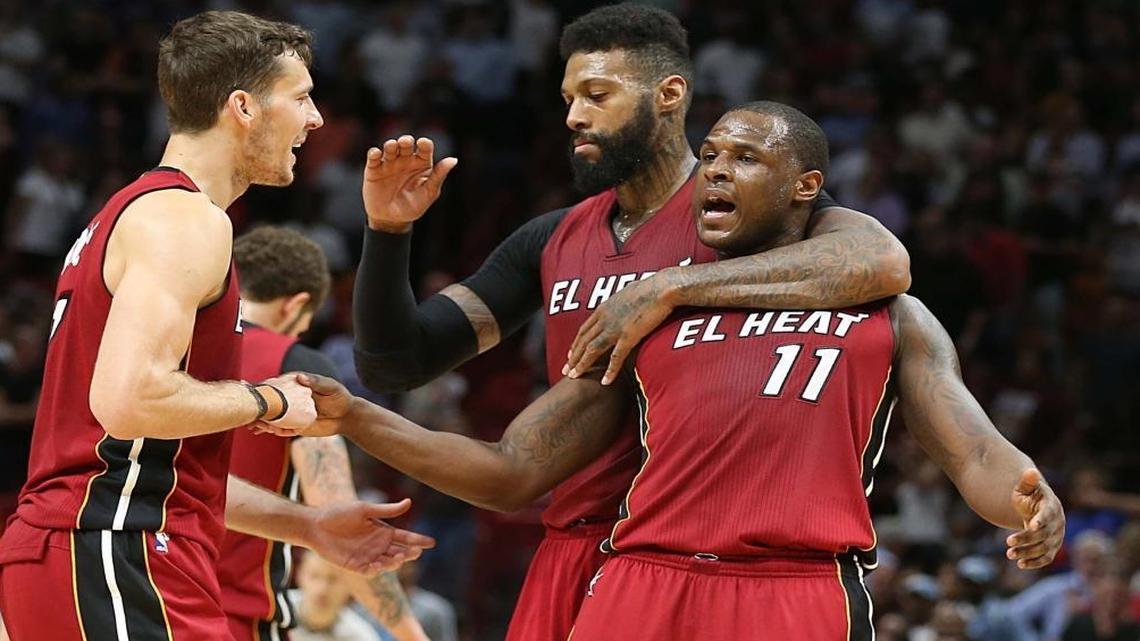 Miami Heat forward James Johnson and guard Goran Dragic greet Dion Waiters as they lead in the fourth quarter of the Miami Heat and Charlotte Hornets game at AmericanAirlines Arena in Miami on Wed., March 8, 2017.
