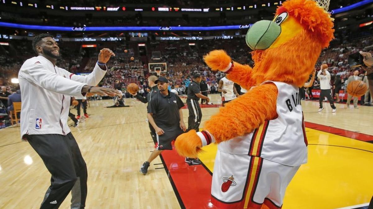 Miami Heat forward Willie Reed (35) dances with Burnie on the court as the Miami Heat host the Charlotte Hornets in the home opener at AmericanAirlines Arena. on Fri., Oct. 28, 2016.