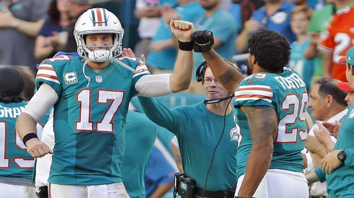 Miami Dolphins quaterback Ryan Tannehill celebates with Arian Foster after a throw to Kenny Stills that resulted in a touchdown in the fourth quarter at Hard Rock Stadium in Miami Gardens, Florida on Sun., Oct. 23, 2016.