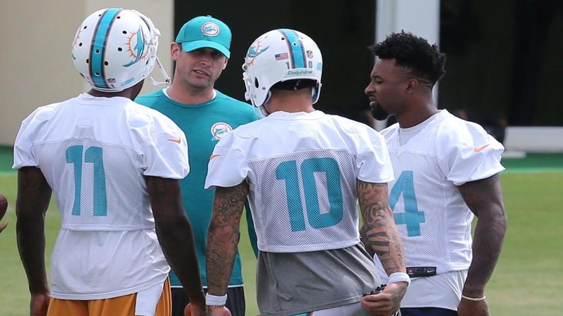 Miami Dolphins coach Adam Gase talks with receivers DeVante Parker (11), Kenny Stills (10), and Jarvis Landry (14), during minicamp at the Miami Dolphins training facility in Davie, FL, June 13, 2017.