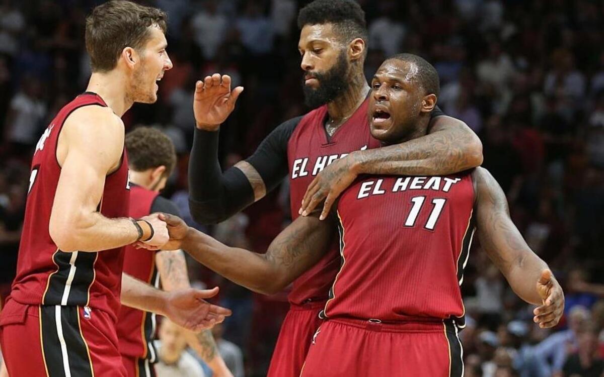 Miami Heat forward James Johnson and guard Goran Dragic, greet Dion Waiters as they lead in the fourth quarter of the Miami Heat and Charlotte Hornets game at AmericanAirlines Arena in Miami on Wed., March 8, 2017.
