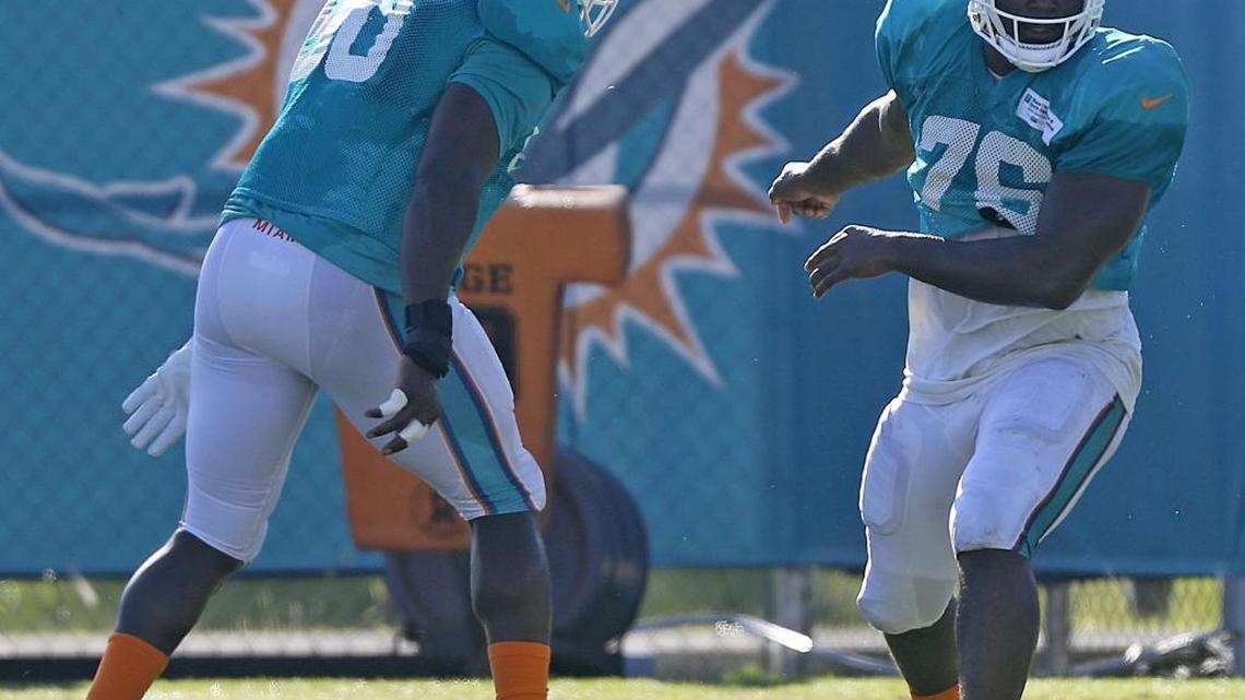 On Sunday, August 13, 2017 Miami Dolphins defensive lineman Praise Martin-Oguike #76, works on drills with team Anthony Fasano, left, during training camp at the team's training facility in Davie, Florida.