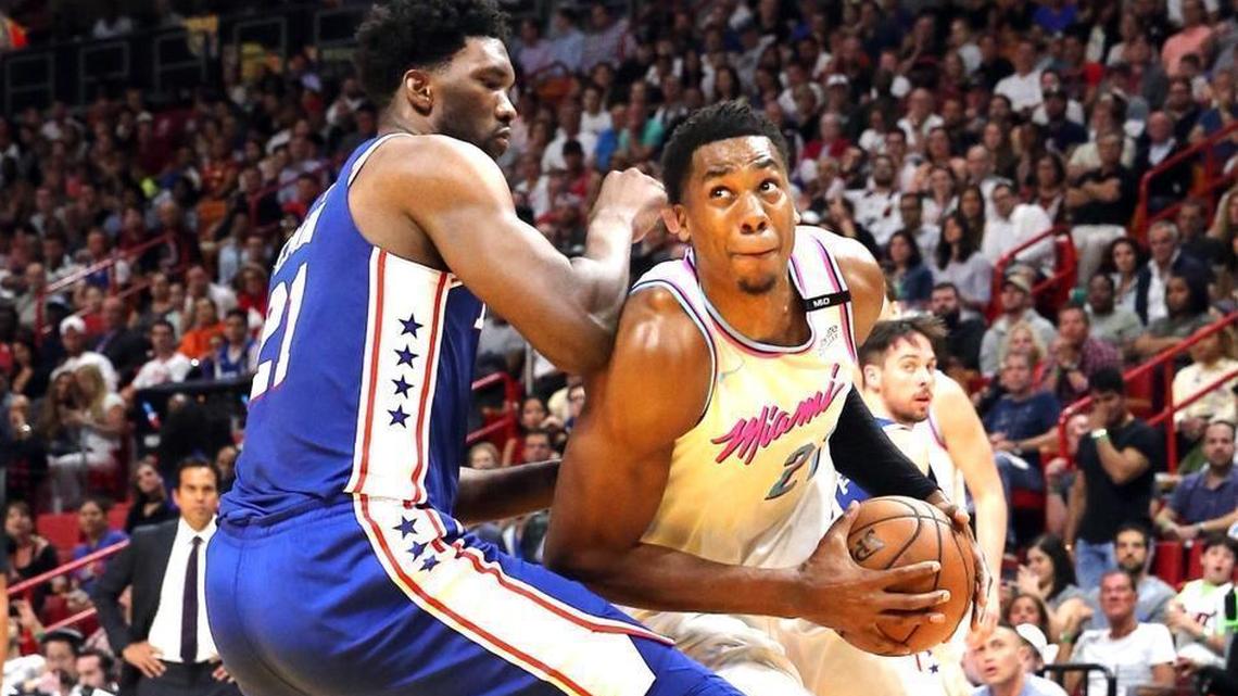 The Miami Heat's Hassan Whiteside, right, looks to the basket as the Philadelphia 76ers' Joel Embiid defends him. (Charles Trainor Jr./Miami Herald/TNS)