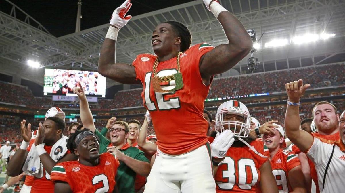 Miami Hurricanes defensive back Malek Young (12) wears the turnover chain after intercepting a pass against Notre Dame on Nov. 11.
