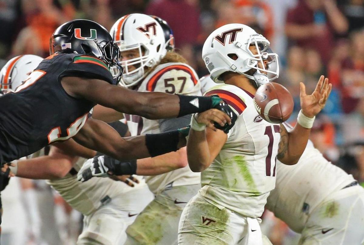 Miami Hurricanes defensive end Jonathan Garvin knocks the ball loose from former Virginia Tech Hokies quarterback Josh Jackson in 2017. The teams meet again Oct. 5 at Hard Rock Stadium.