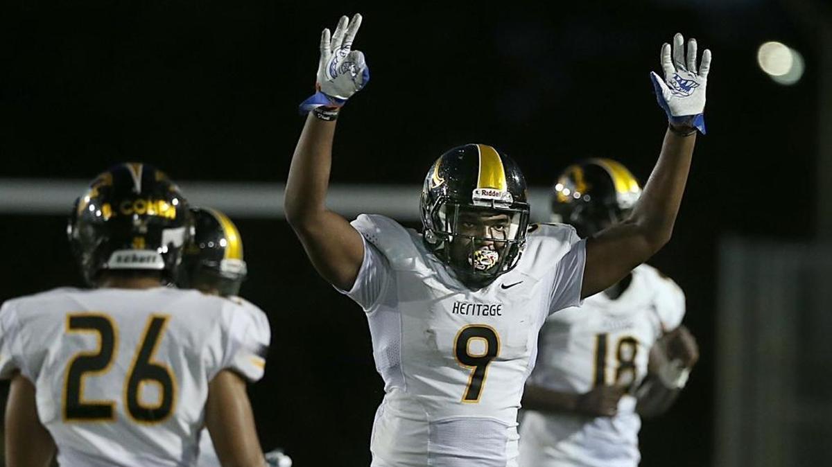 Plantation American Heritage defensive line Andrew Chatfield celebrates a TD against the Booker T. Washington on Aug. 18. UM is recruiting Chatfield to shore up its defensive line.