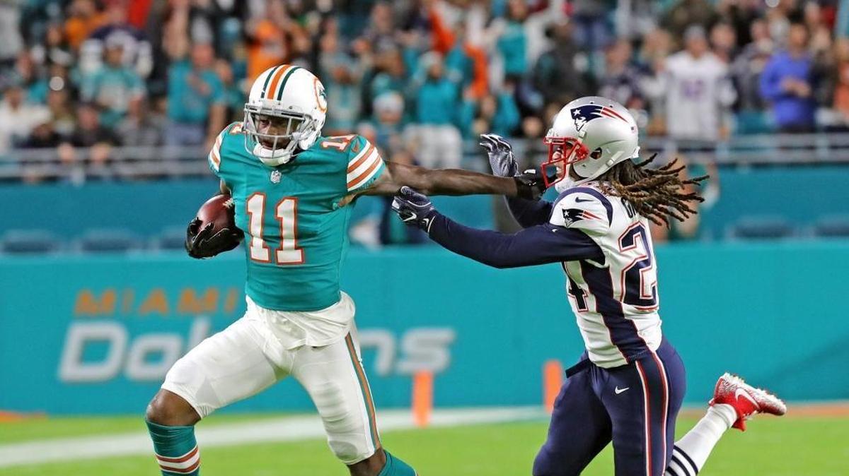 Miami Dolphins receiver DeVante Parker (11) catches a first quarter pass against New England in the Monday Night Football game last December. His position coach said Thursday that Parker has changed considerably.