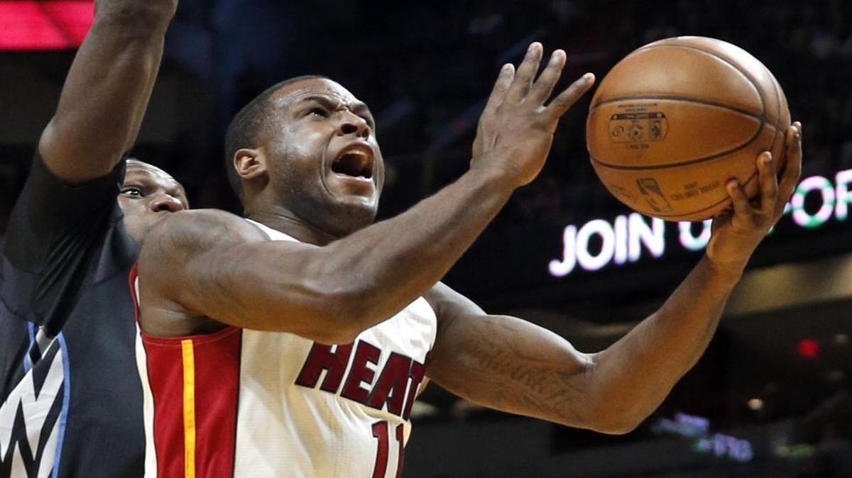 Miami Heat guard Dion Waiters (11) on a lay up past Minnesota Timberwolves forward Gorgui Dieng (5) in the first quarter as the Miami Heat host the Minnesota Timberwolves at the American Airlines Arena on Friday, March 17, 2017.