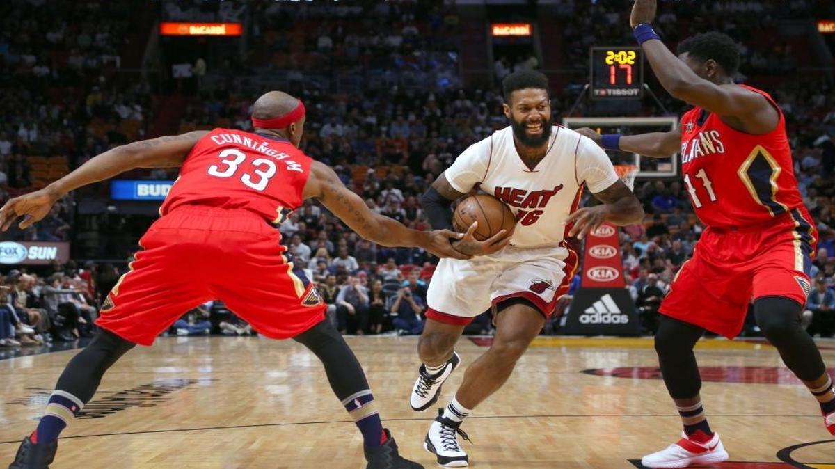 Miami Heat forward James Johnson drives against New Orleans Pelicans forward Dante Cunningham (33) guard Jrue Holiday (11) during the first quarter of an NBA basketball game at AmericanAirlines Arena in Miami on Wed., March 15, 2017.