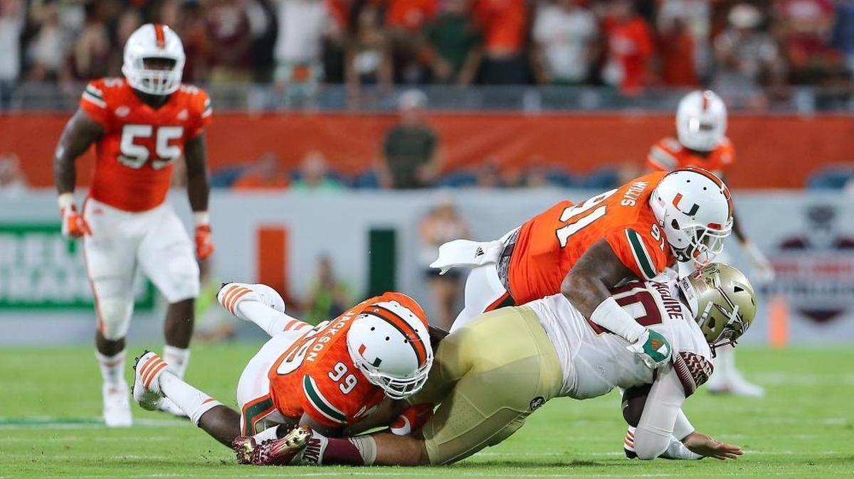 UM defensive tackle Gerald Willis (91) and end Joe Jackson (99) - seen here sacking FSU quarterback Sean McGuire in a 2016 game - will be key pieces on a UM defense that lost several important contributors.