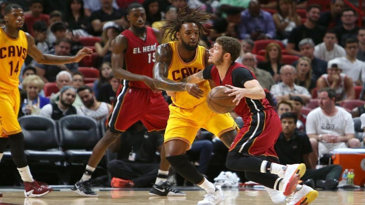 Miami Heat guard Tyler Johnson is fouled by Cleveland Cavaliers forward Derrick William during the fourth quarter of an NBA basketball game at AmericanAirlines Arena in Miami on Sat., March 4, 2017.