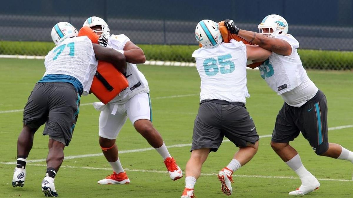 Miami Dolphins offensive linemen run drills during OTAs at the Miami Dolphins' traning facility in Davie, Florida, June 6, 2016.