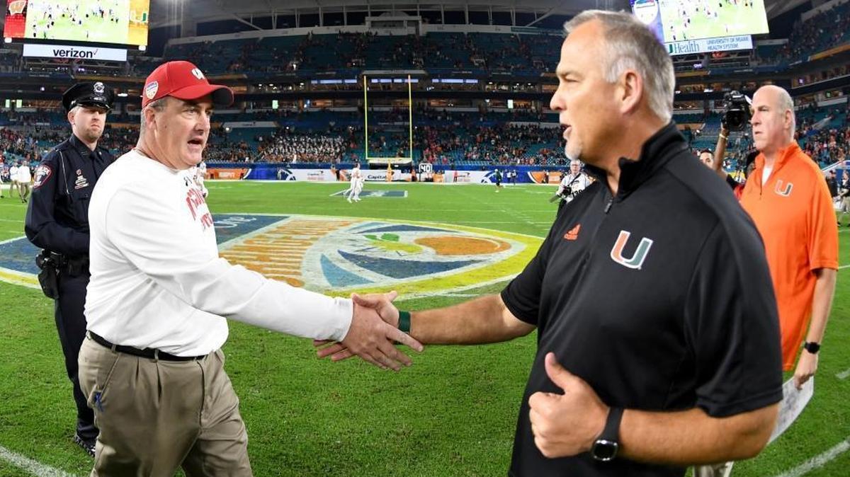 Wisconsin coach Paul Chryst shakes hands with UM coach Mark Richt after Saturday’s Orange Bowl.