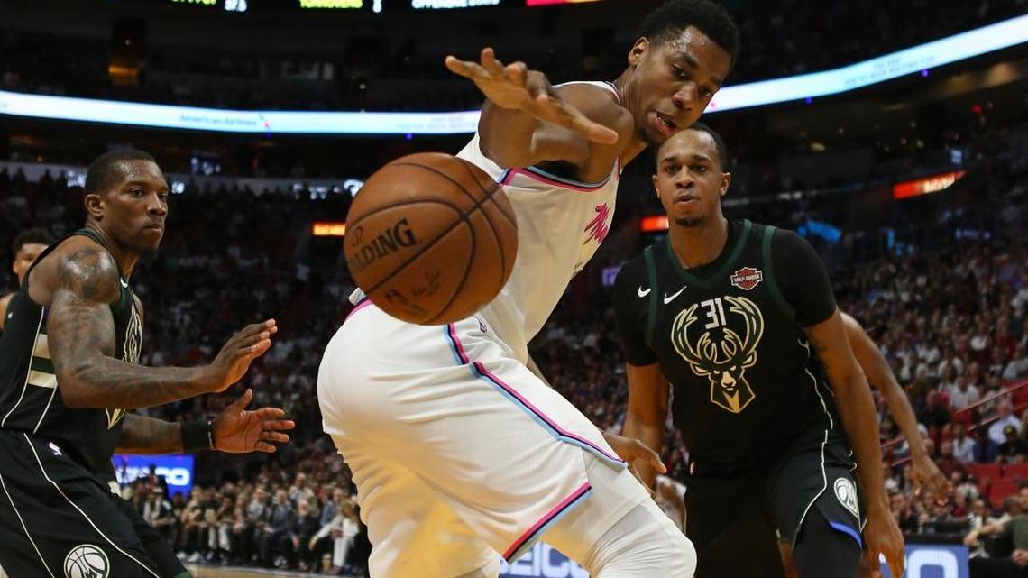Miami Heat center Hassan Whiteside battles for a lose ball against the Milwaukee Bucks last Friday. Whiteside’s minutes are down from a year ago.