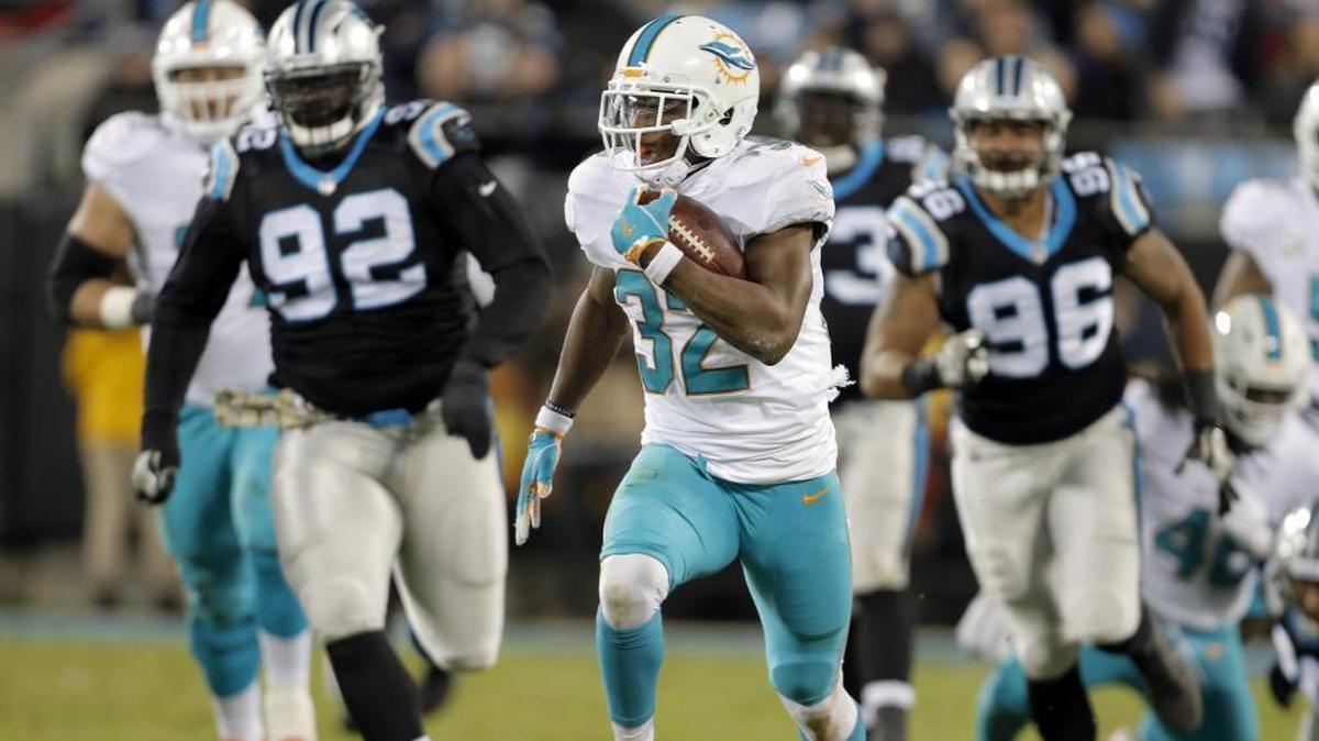 Miami Dolphins' Kenyan Drake (32) runs for a touchdown against the Carolina Panthers on Monday.