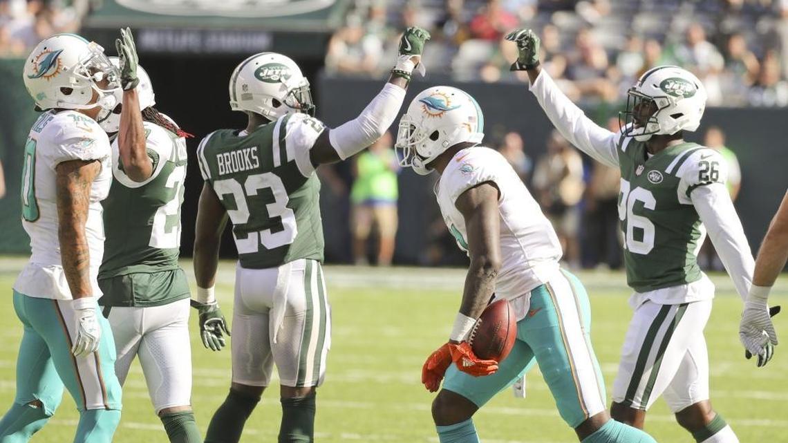 New York Jets defensive back Terrence Brooks (23) and free safety Marcus Maye (26) celebrate after Miami Dolphins wide receiver DeVante Parker (11) is short of a first on a fourth down attempt in the fourth quarter as the New York Jets host the Miami Dolphins at Met Life Stadium on Sunday, September 24, 2017.