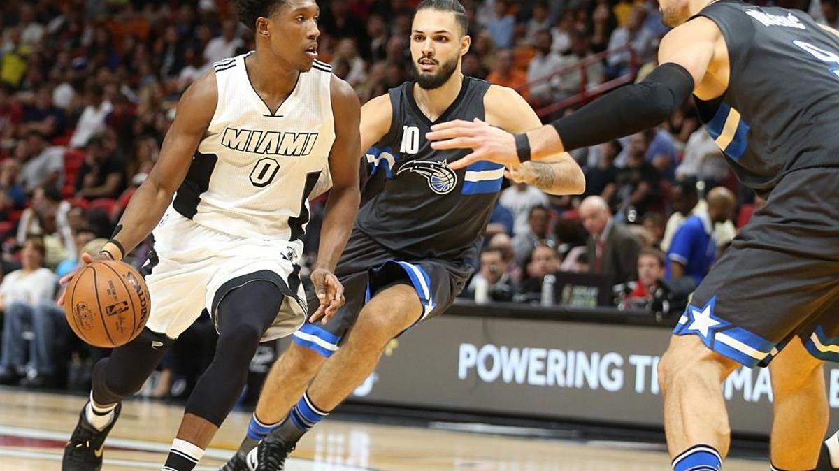 Miami Heat guard Josh Richardson, drives against Magic's Evan Fournier #10 and Nikola Vucevic, in the second quarter of the Miami Heat vs Orlando Magic, NBA game at AmericanAirlines Arena in Miami on Tuesday, December 20, 2016.