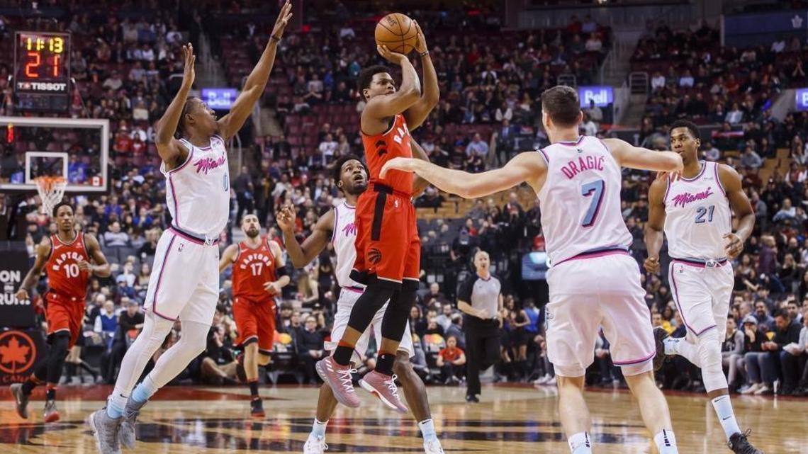 Toronto Raptors' Kyle Lowry puts up a shot against Miami Heat, left to right, Josh Richardson, Goran Dragic, and Hassan Whiteside during Tuesday’s Heat loss.