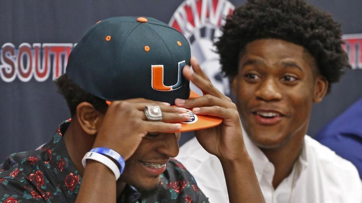 Teammates Mark Pope, left, and Daquris Wiggins, right, both signed with UM on Wednesday.
