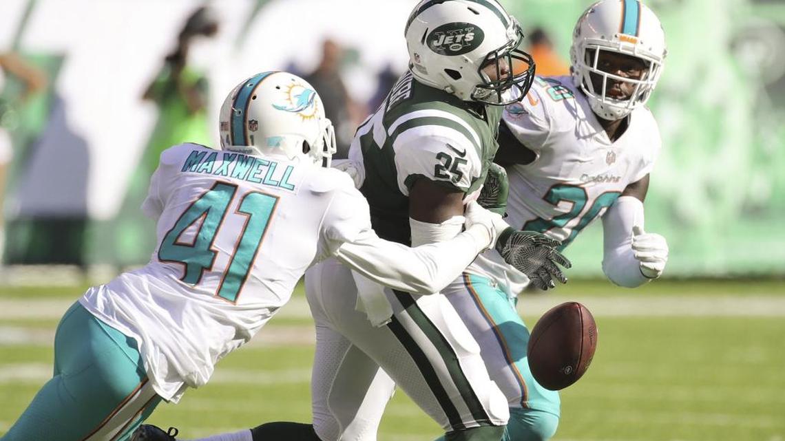 Miami Dolphins cornerback Byron Maxwell (41) causes the Jets running back Elijah McGuire (25) to fumble in the fourth quarter as the New York Jets host the Miami Dolphins at Met Life Stadium on Sunday, September 24, 2017.