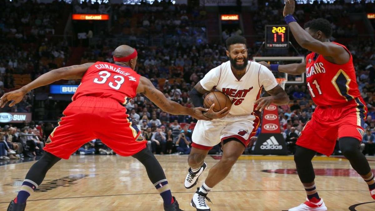 Miami Heat forward James Johnson drives against New Orleans Pelicans forward Dante Cunningham (33) guard Jrue Holiday (11) during the first quarter of an NBA basketball game at AmericanAirlines Arena in Miami on Wed., March 15, 2017.