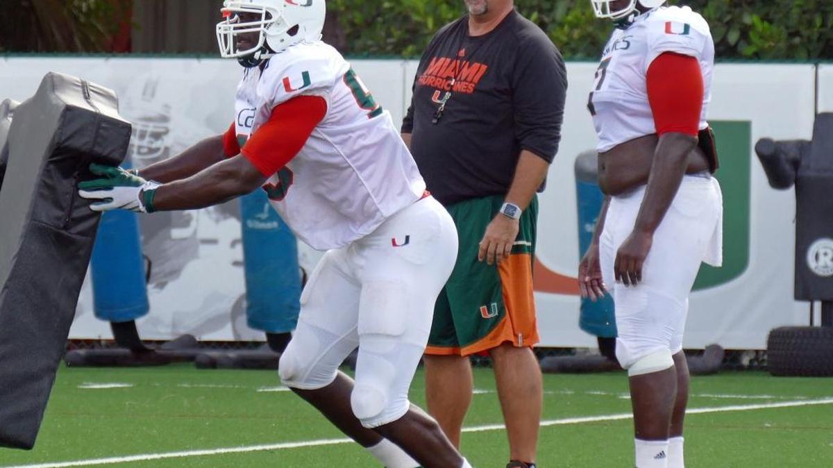 University of Miami defensive line football coach, Craig Kuligowski works with the team during practice, Monday morning, Aug. 15 , 2016.
