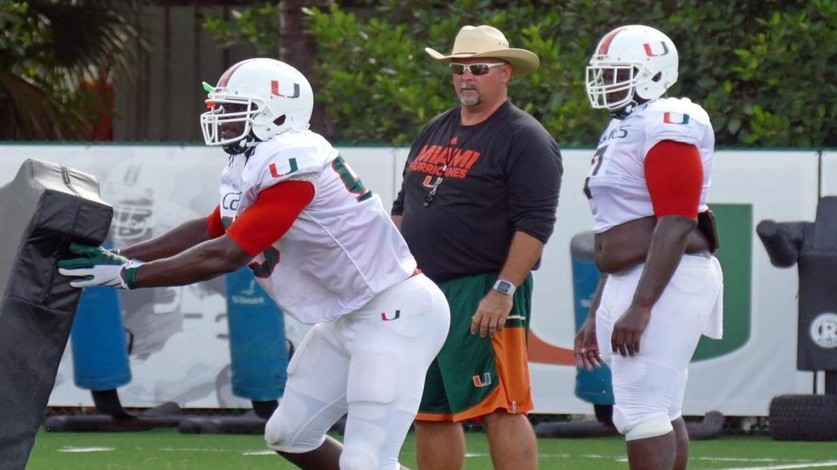 University of Miami defensive line football coach, Craig Kuligowski works with the team during practice.
