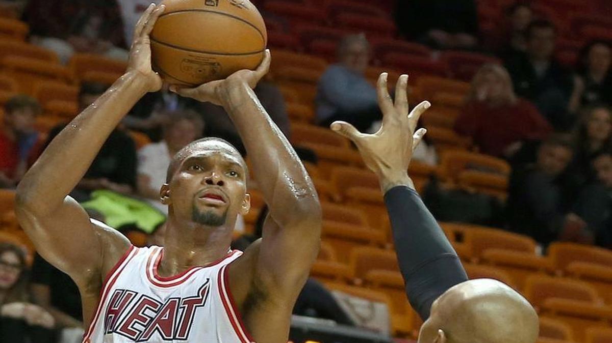 Chris Bosh of the Miami Heat shoots over David West in the fourth quarter of a game at AmericanAirlines Arena in Miami on Tuesday, Feb. 9, 2016.