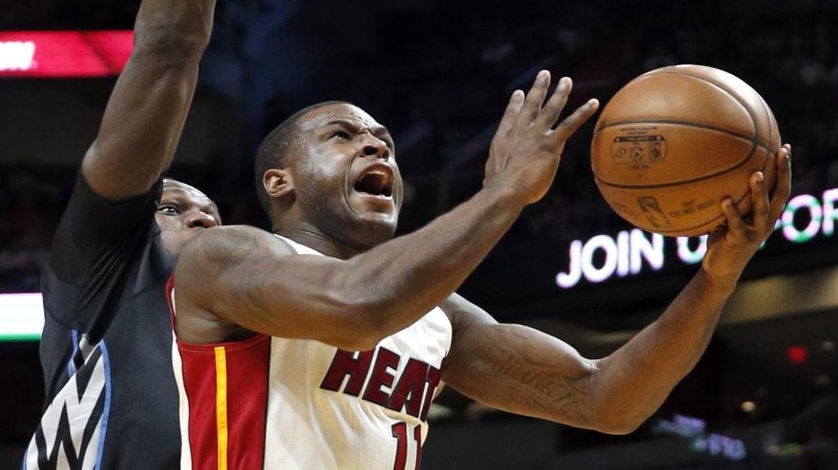 Miami Heat guard Dion Waiters (11) on a lay up past Minnesota Timberwolves forward Gorgui Dieng (5) in the first quarter at the American Airlines Arena on Friday, March 17, 2017.