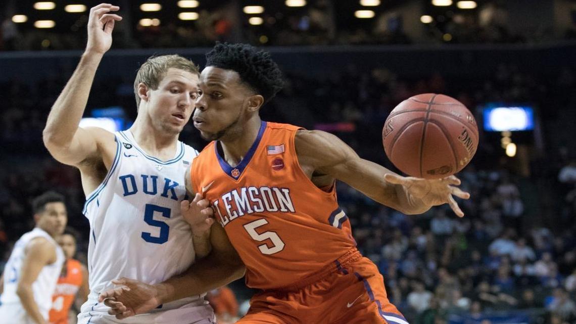 Duke guard Luke Kennard, left, guards Clemson forward Jaron Blossomgame during the first half of an NCAA college basketball game in the Atlantic Coast Conference tournament, Wednesday, March 8, 2017, in New York.