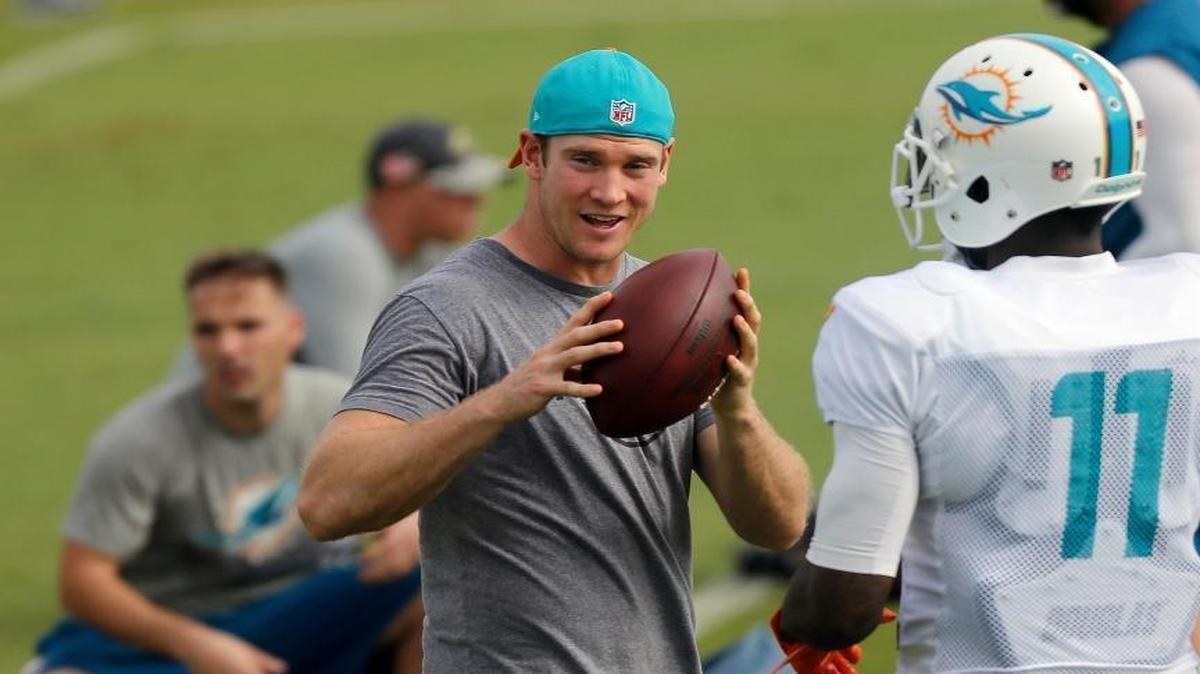 Dolphins starting quarterback, Ryan Tannehill, left, talks with DeVante Parker, Dolphins wide receiver, during practice. Tannihill did not practice but was on the field as the Dolphins practice for their upcoming playoff game against the Steelers at their team's practice facility in Davie, Florida on Wednesday, January 4, 2017.