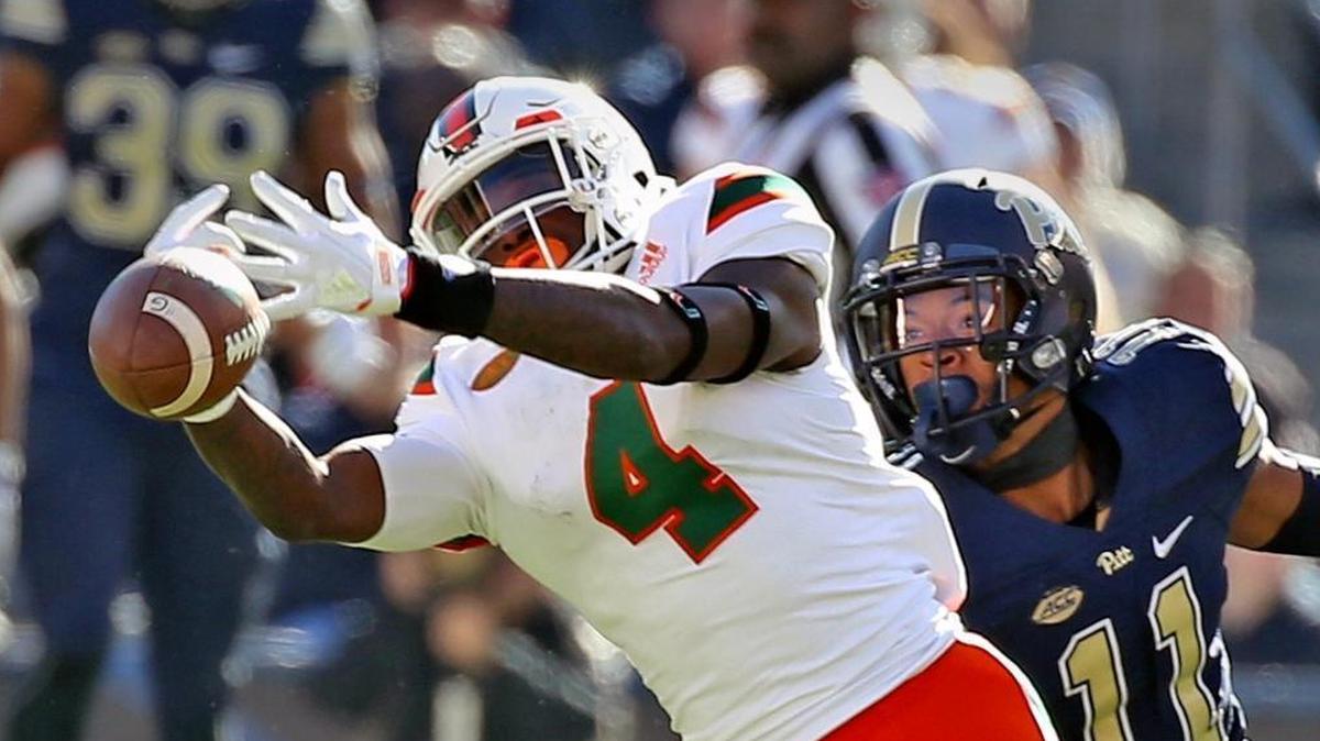 Miami Hurricanes receiver Jeff Thomas (4) tries to catch a first quarter pass as Pitt Panthers cornerback Daniel Jackson (11) defends him in a game last November. Thomas has drawn raves this offseason.