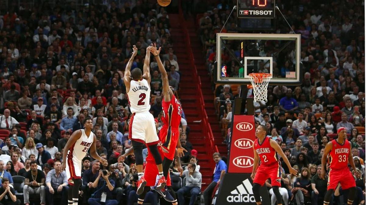 Miami Heat guard Wayne Ellington hits a three pointer against New Orleans Pelicans guard E'Twaun Moore (55) during the fourth quarter of an NBA basketball game at AmericanAirlines Arena in Miami on Wednesday, March 15, 2017.