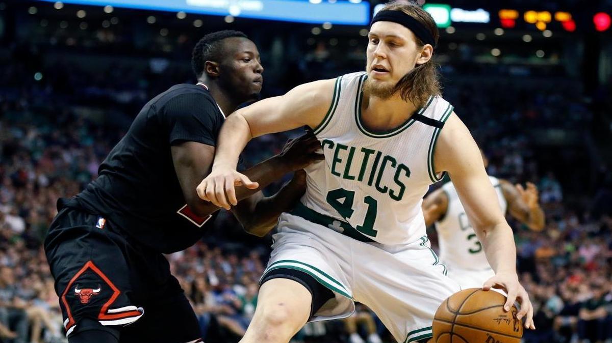 Chicago Bulls' Jerian Grant defends Boston Celtics' Kelly Olynyk (41) during a first-round NBA playoff basketball game in Boston. The Miami Heat struck a four-year deal with Olynyk, a free agent.