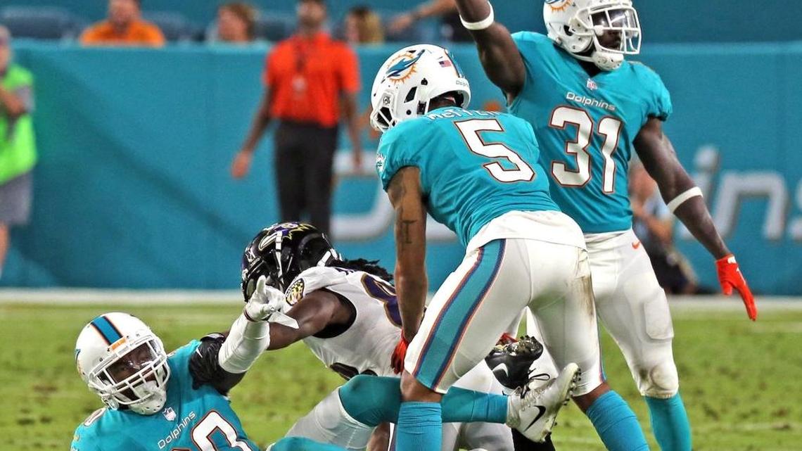 Dolphins Cordrea Tankersley (30) intercepts a pass from Ravens Quincey Adeboyejo (88) in the second quarter as the Miami Dolphins play the Baltimore Ravens in their second preseaon game at Hard Rock Stadium in Miami Gardens, FL, August 17, 2017.