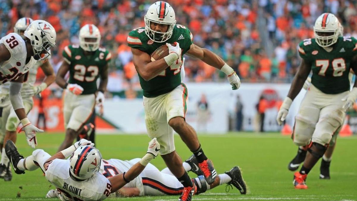 Miami Hurricanes running back Travis Homer (24) breaks a tackle for a touchdown against Virginia on  November 18, 2017. Homer was nominated for the Maxwell Award on Monday, July 16, 2018.