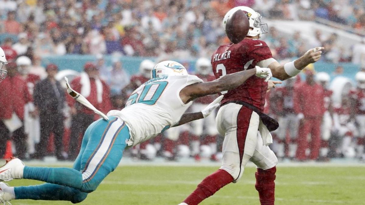 Miami Dolphins defensive end Andre Branch (50) causes a fumble by Arizona Cardinals quarterback Carson Palmer (3) in the third quarter as the Miami Dolphins host Arizona Cardinals at Hard Rock Stadium on Sun., Dec. 11, 2016.