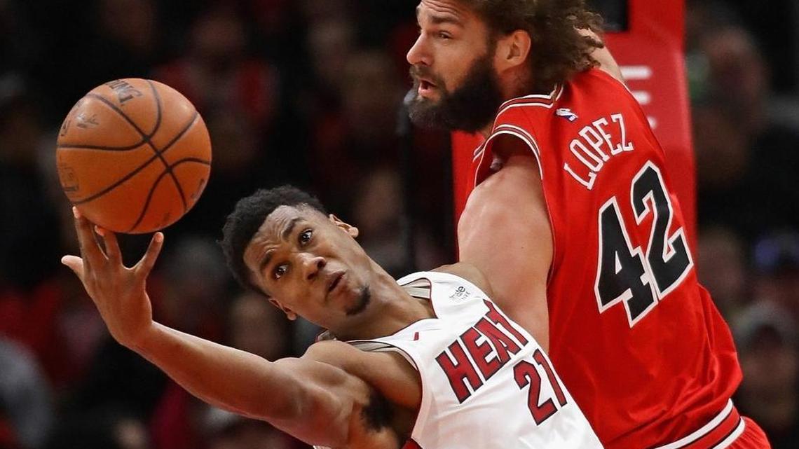 Heat center Hassan Whiteside reaches for a rebound against Chicago’s Robin Lopez in Monday’s game. Entering Wednesday’s game in Milwaukee, Whiteside hadn’t played in the fourth quarter of five of the past 10 games. (Photo by Jonathan Daniel/Getty Images)