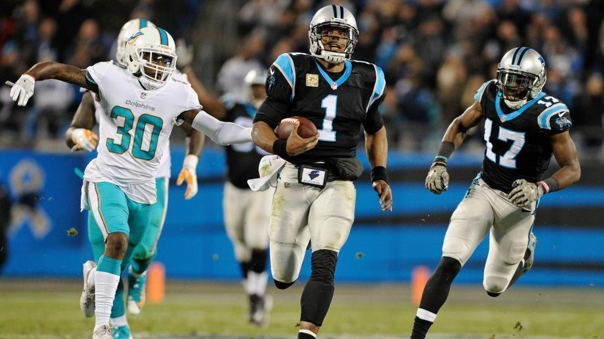 Carolina Panthers' Cam Newton (1) runs past Miami Dolphins' Cordrea Tankersley (30) for a long gain in the second half of an NFL football game in Charlotte, N.C., Monday, Nov. 13, 2017. (AP Photo/Mike McCarn)