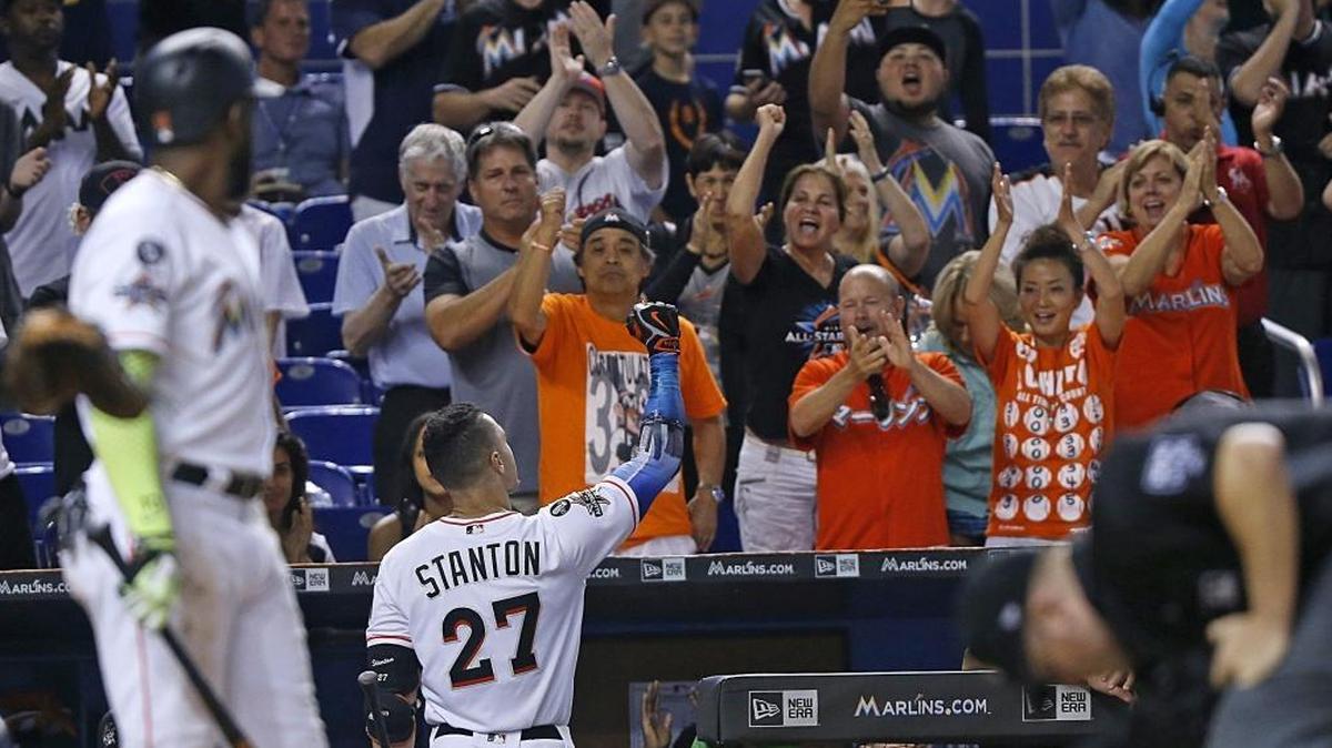 Giancarlo Stanton, center, gets a standing ovation from some fans after striking out at the bottom of the 9th inning. That game against Atlanta proved to be his final appearance as a Marlin. He was traded to the Yankees this offseason.