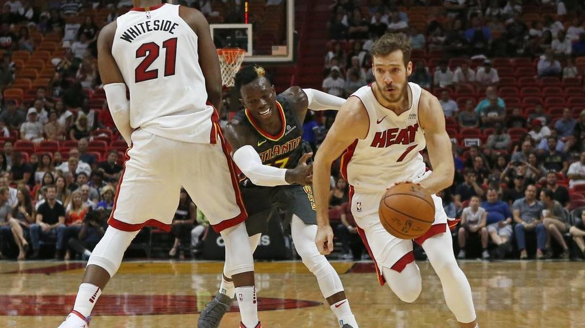 Miami Heat center Hassan Whiteside #21 sets a screen for teammate guard Goran Dragic as he drives against Atlanta Hawks guard Dennis Schroder #17 during the second quarter of an NBA preseason basketball game at the AmericanAirlines Arena in Miami on Sunday, October 1, 2017.
