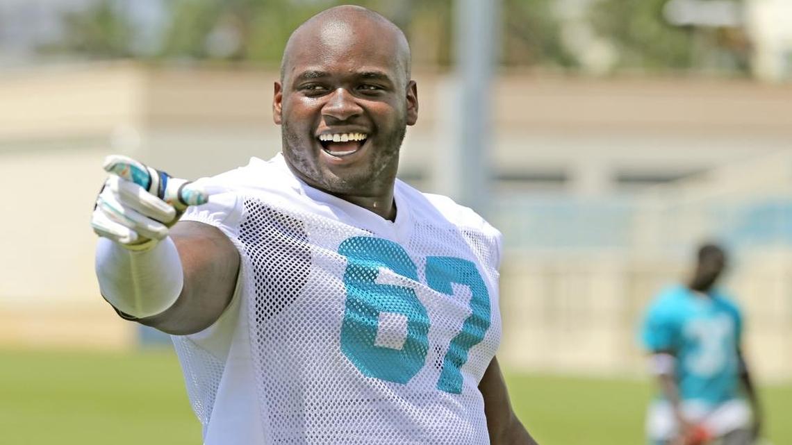 Miami Dolphins Laremy Tunsil (67) gestures as he walks off the field during Dolphins mini-camp at Doctors Hospital Training Facility at Nova Southeastern University on Thurs., June 16, 2016